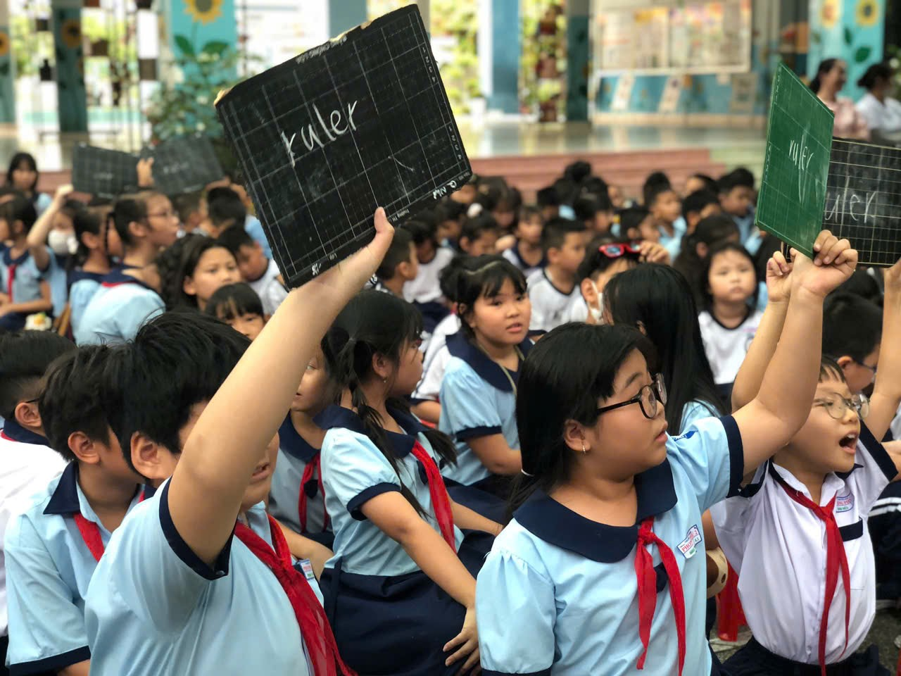 A group of children holding signs Description automatically generated