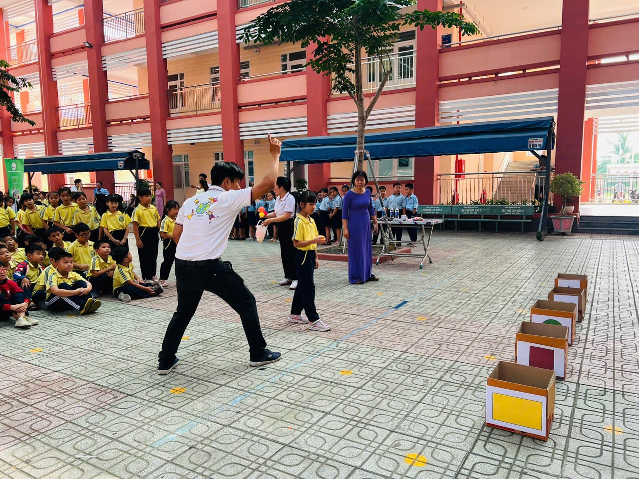 A group of people in a courtyard Description automatically generated