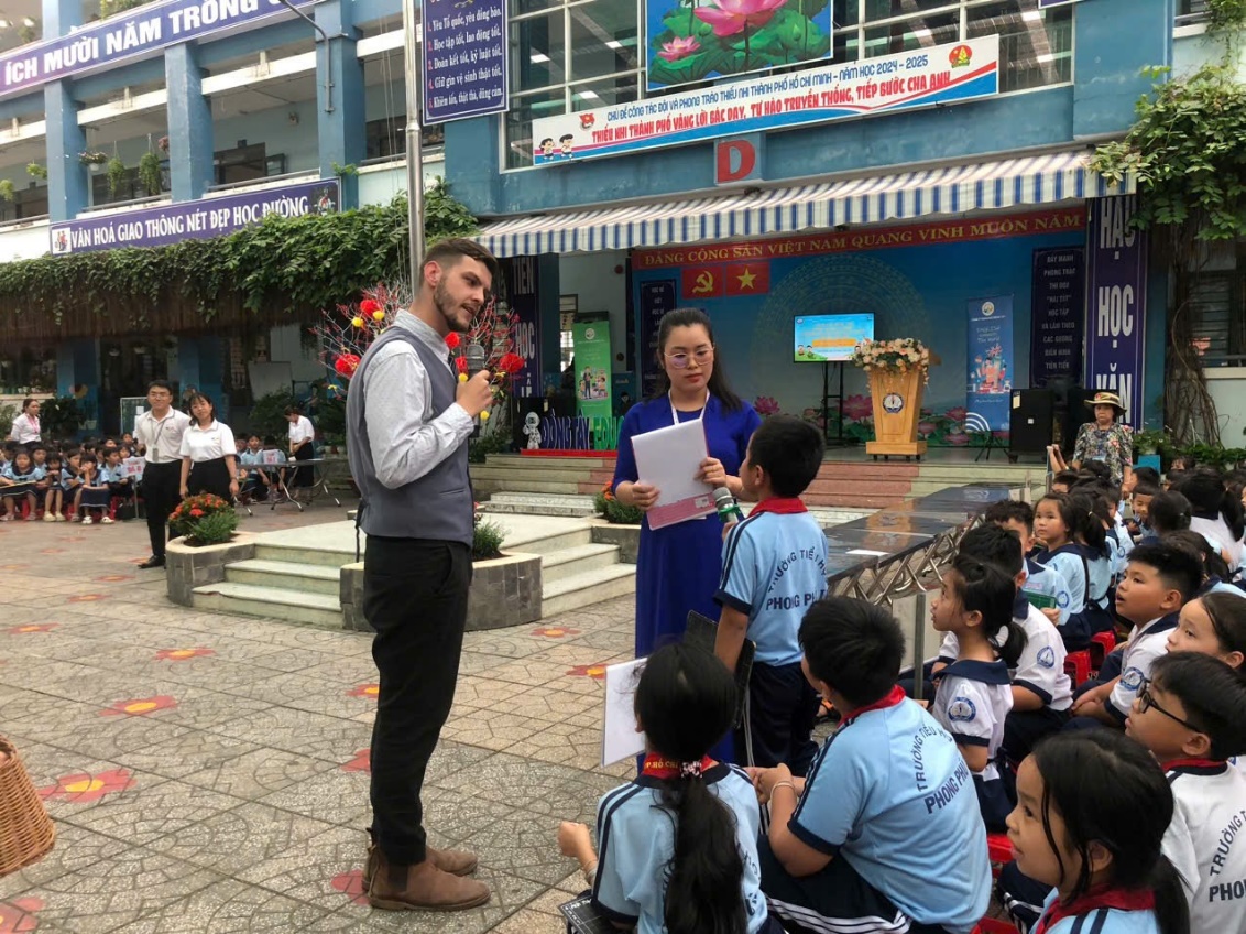 A person standing in front of a group of children Description automatically generated